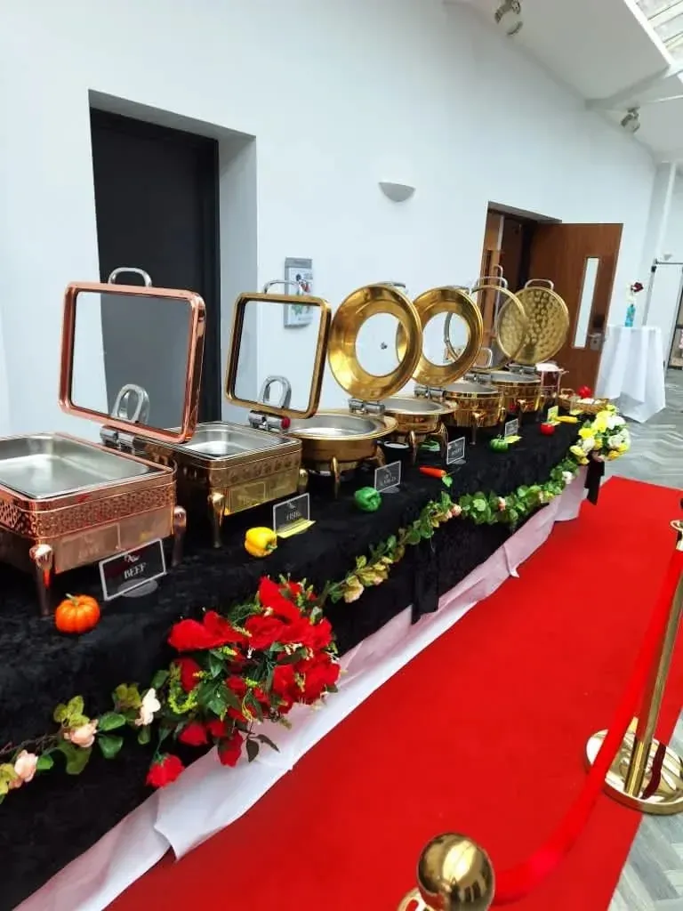 Anny's gold chafing dishes on a red carpet